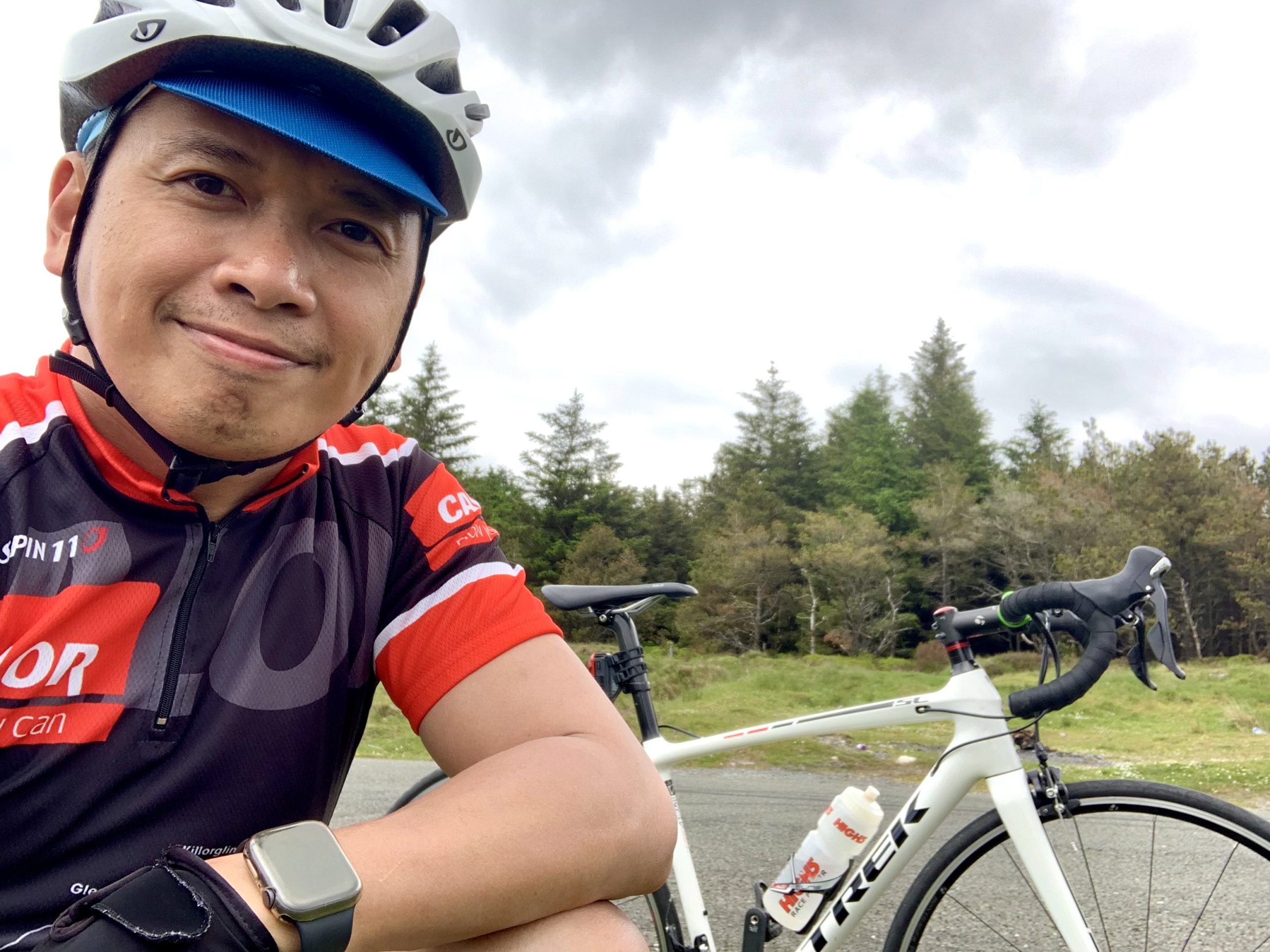 Reggie kneeling near his bike