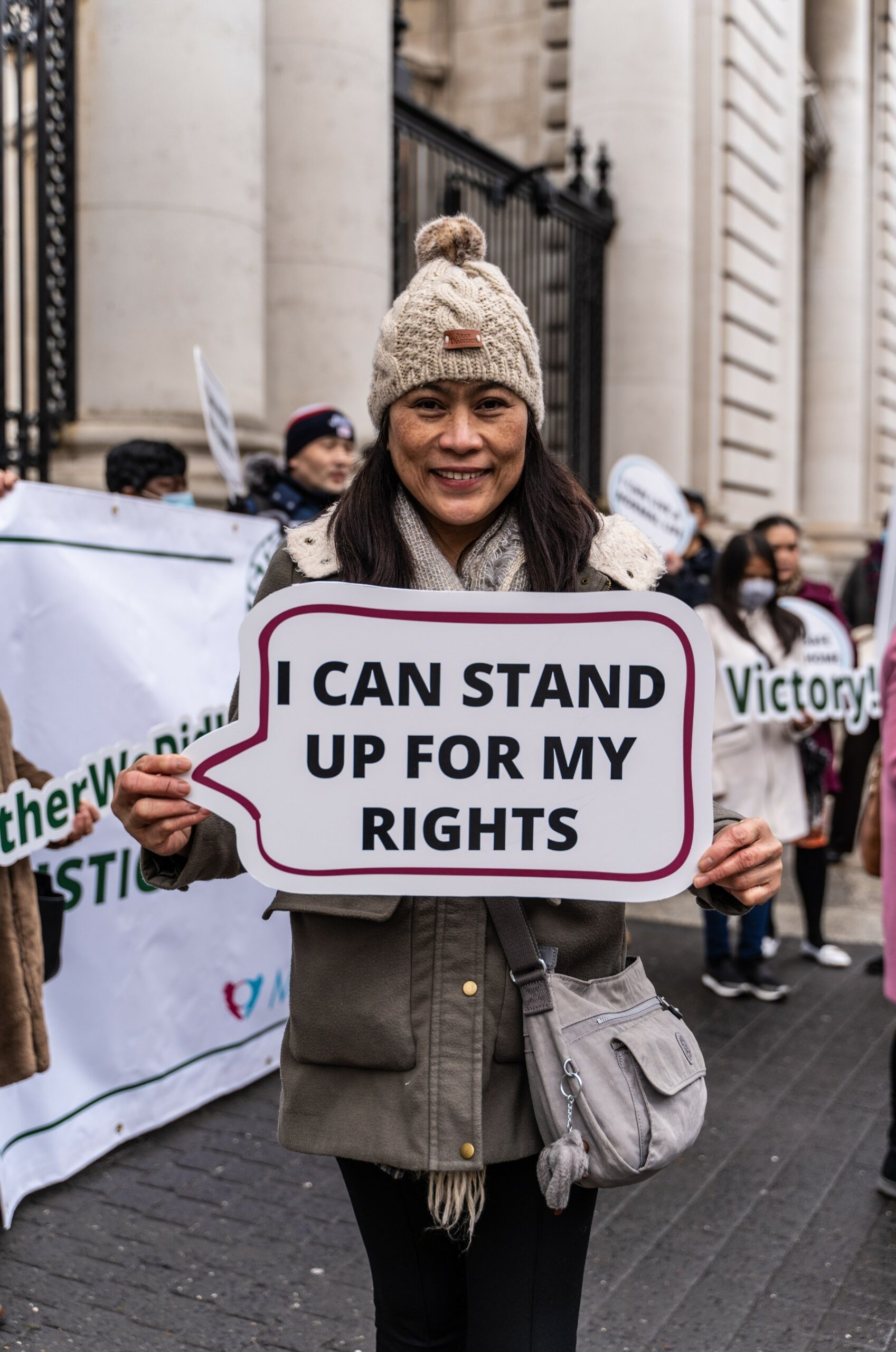 Mel holding up placard